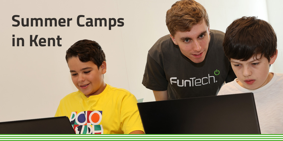 Summer Camps in Kent: 2 young boys on laptops with FunTech tutor standing over shoulder teaching.